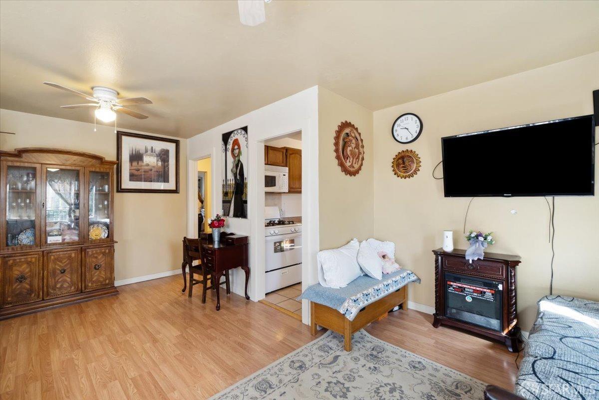 1309 80th Avenue Oakland, CA 94621 - Photo 38 of 75 a living room with furniture and a flat screen tv