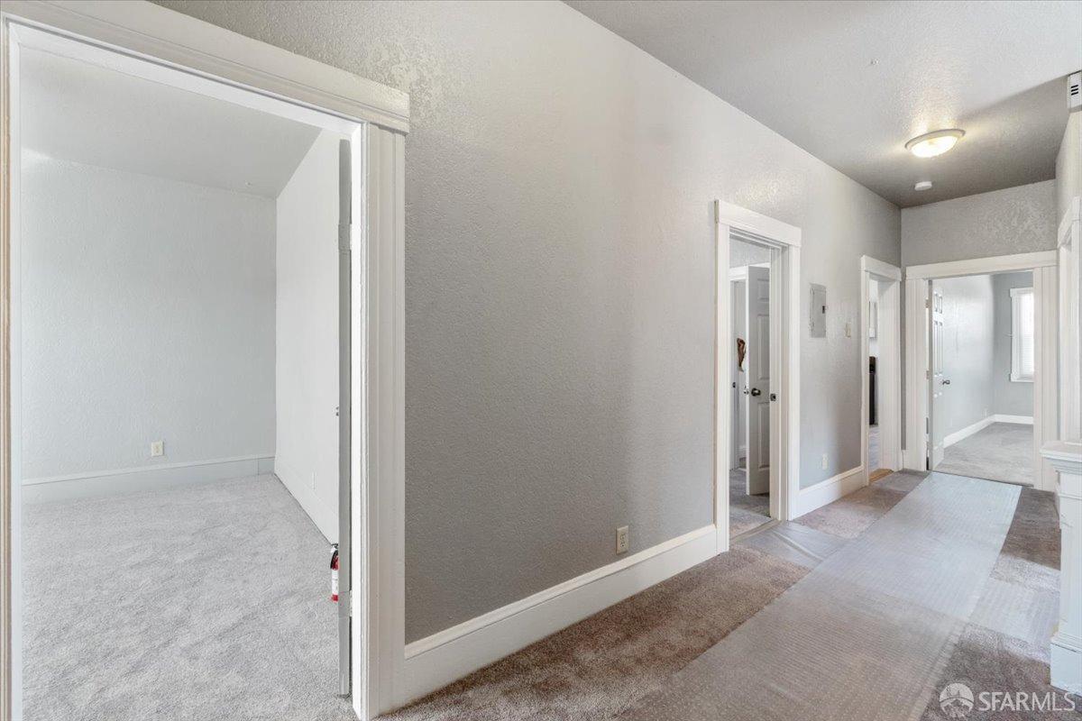 1309 80th Avenue Oakland, CA 94621 - Photo 4 of 75 a view of a hallway with wooden shelves