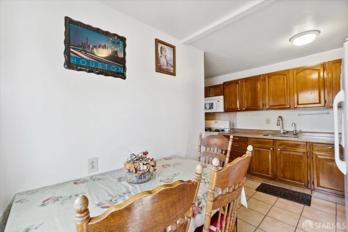 1309 80th Avenue Oakland, CA 94621 - Photo 43 of 75 a kitchen with a sink stove and cabinets