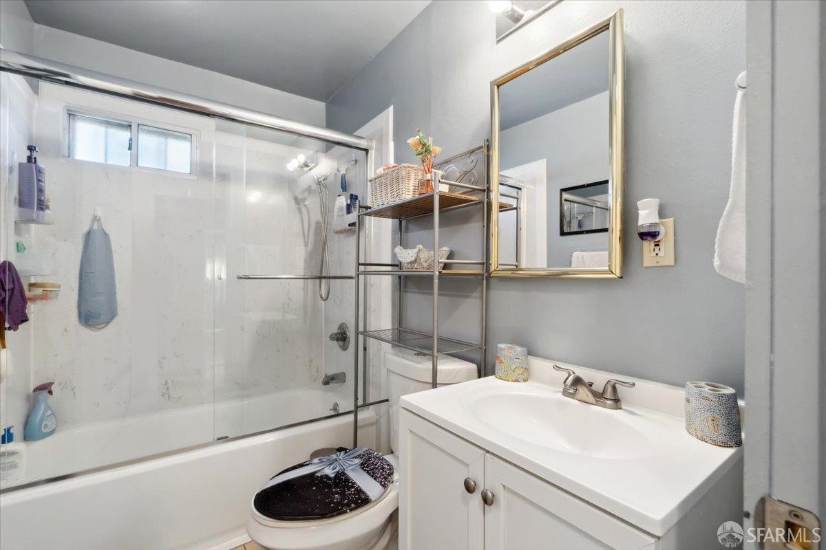 1309 80th Avenue Oakland, CA 94621 - Photo 46 of 75 a bathroom with a sink a toilet and shower