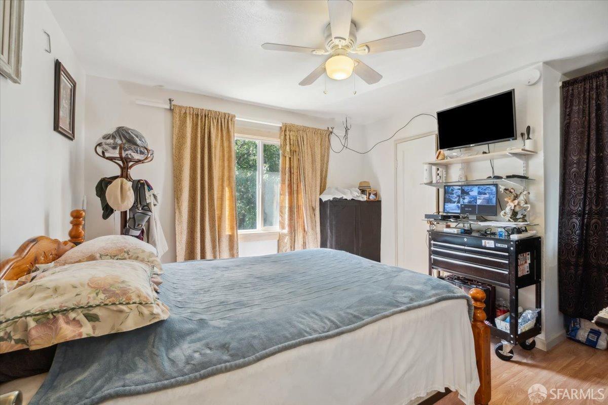 1309 80th Avenue Oakland, CA 94621 - Photo 50 of 75 a bedroom with a bed and a flat tv screen on the dresser