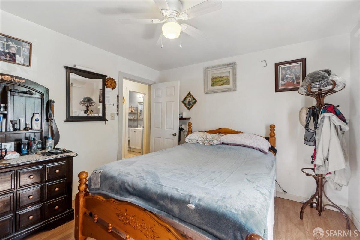 1309 80th Avenue Oakland, CA 94621 - Photo 52 of 75 a bedroom with a bed and a chandelier
