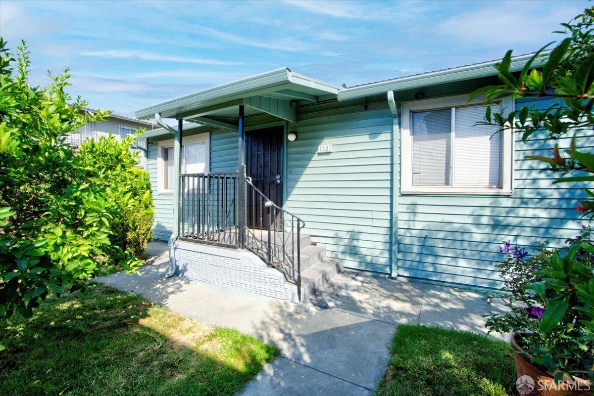 1309 80th Avenue Oakland, CA 94621 - Photo 56 of 75 a yellow house with trees in front of it