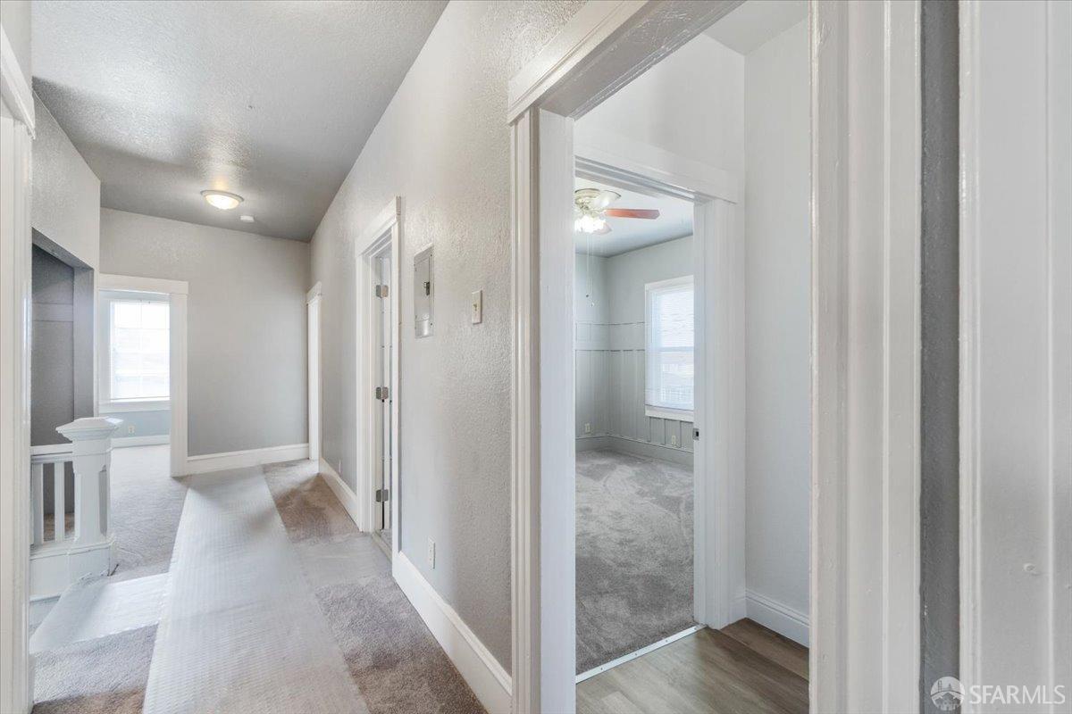1309 80th Avenue Oakland, CA 94621 - Photo 6 of 75 a view of a hallway with toilet and a bathroom