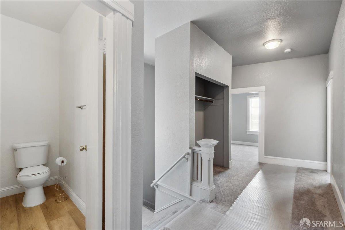1309 80th Avenue Oakland, CA 94621 - Photo 7 of 75 a bathroom with a toilet and a sink