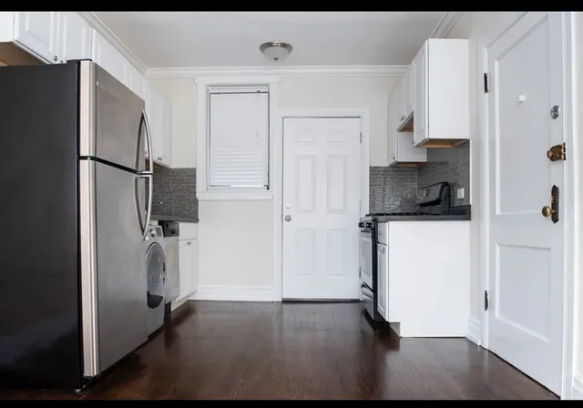a kitchen with a refrigerator and a sink