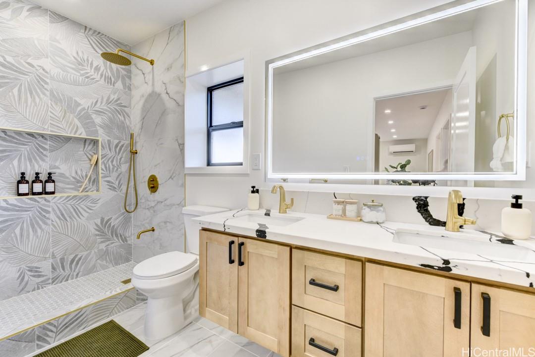 1159 Loho Street Kailua, HI 96734 - Photo 19 of 25 a bathroom with a granite countertop sink mirror vanity and toilet