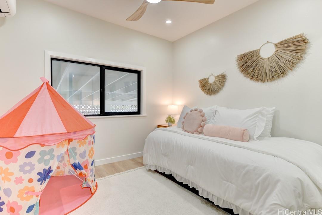 1159 Loho Street Kailua, HI 96734 - Photo 21 of 25 a bedroom with a bed and a painting on the wall