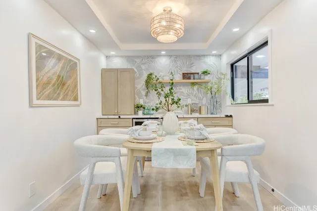 a view of a dining room with furniture and a chandelier