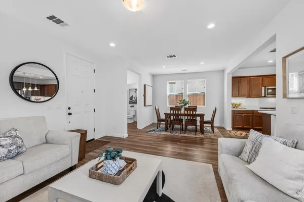 a living room with furniture a fireplace and a flat screen tv