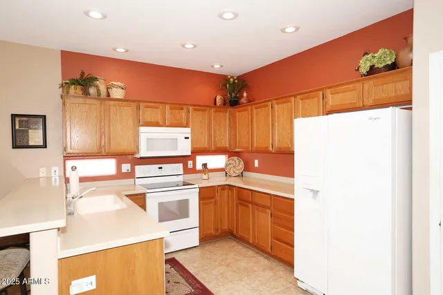 a kitchen with a sink a stove and cabinets