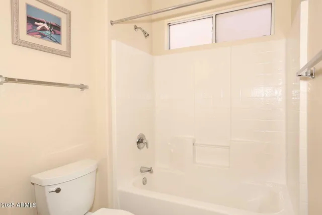 a bathroom with a bathtub and a toilet