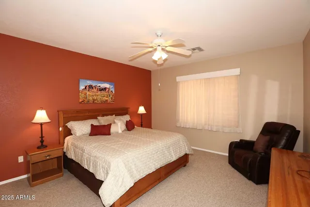 a bedroom with a bed and a lamp