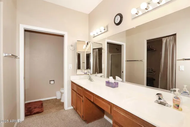 a bathroom with a double vanity sink and a mirror