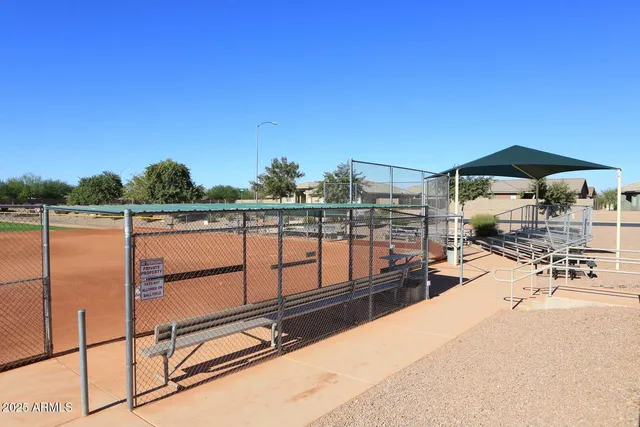 a front view of a house with palm trees