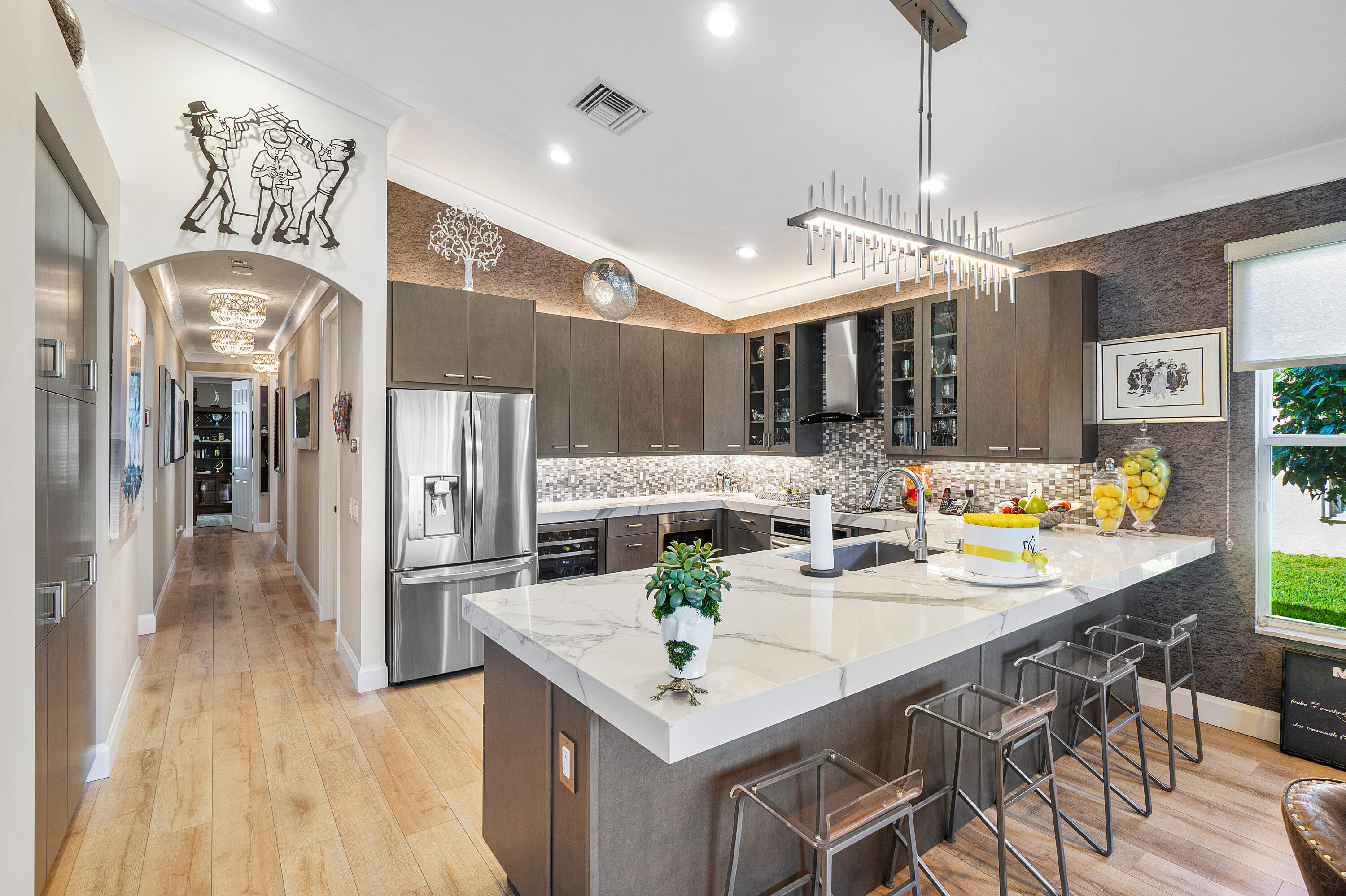 13506 Shell Beach Court Delray Beach, FL 33446 - Photo 17 of 66 a kitchen with stainless steel appliances kitchen island granite countertop a table chairs and a chandelier