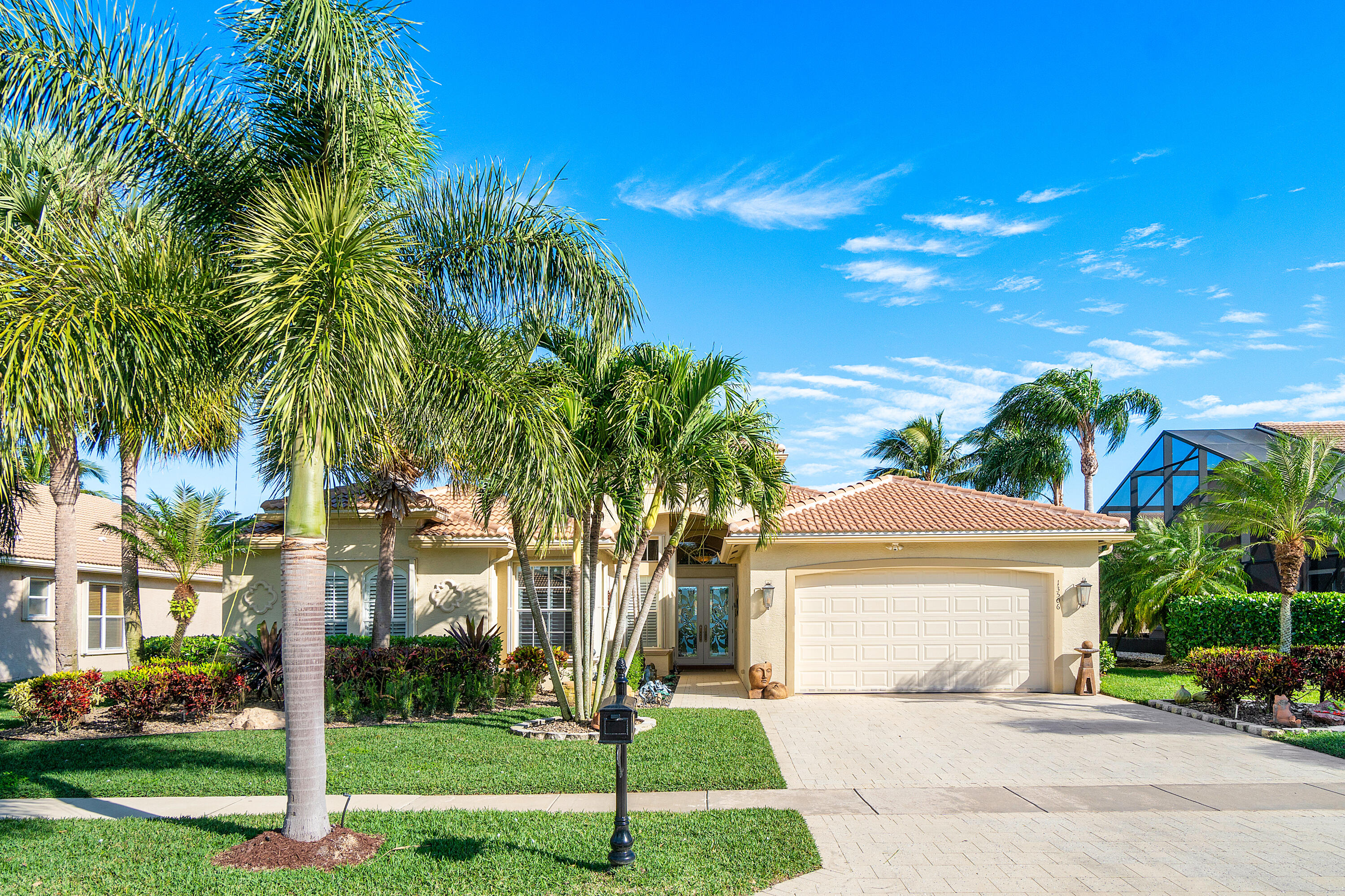 13506 Shell Beach Court Delray Beach, FL 33446 - Photo 2 of 66 a front view of a house with a yard and garage