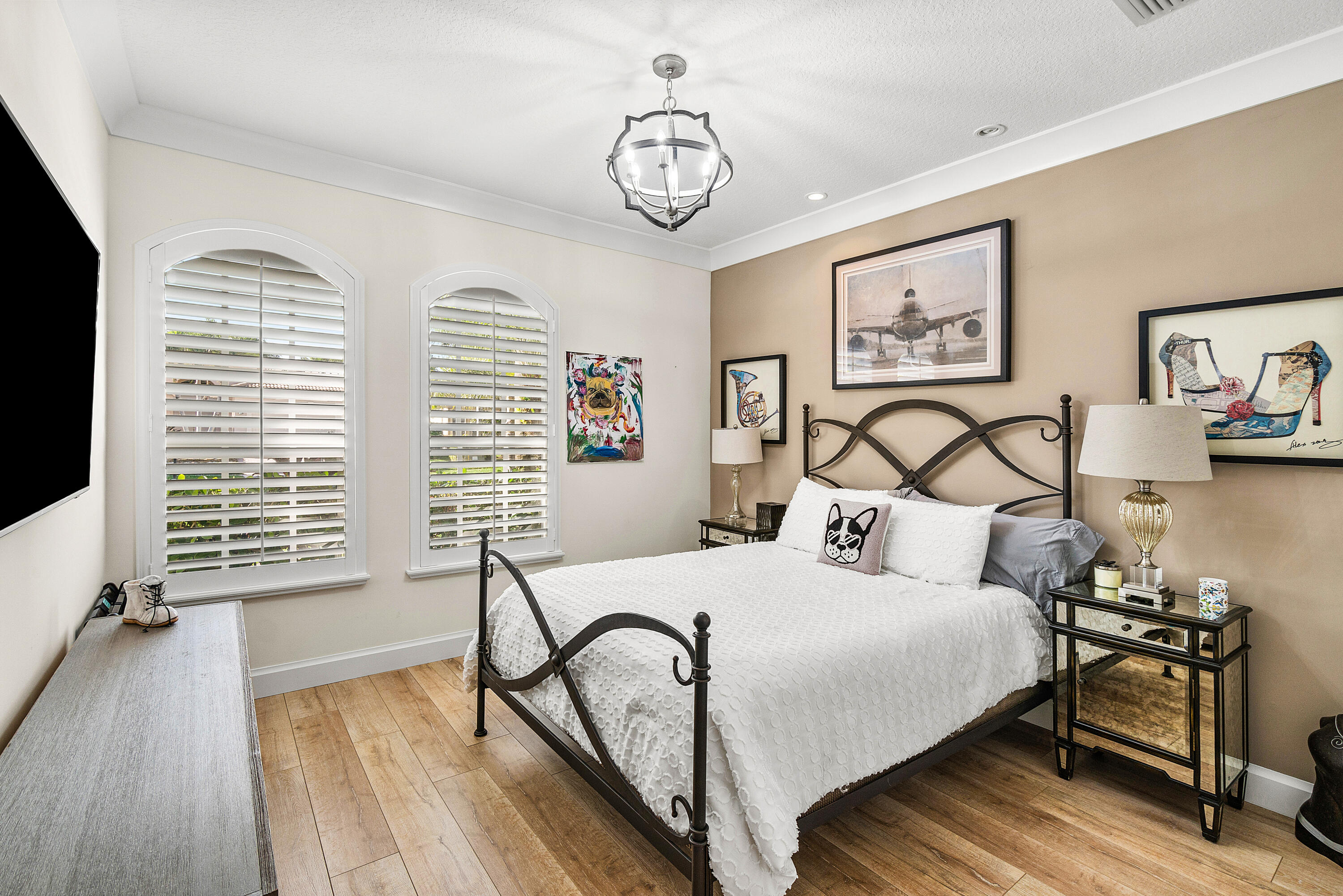 13506 Shell Beach Court Delray Beach, FL 33446 - Photo 33 of 66 a bedroom with a bed a dresser and wooden floor