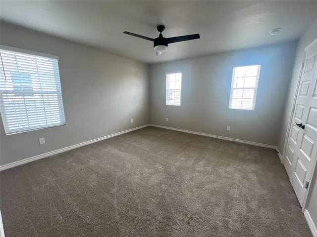 a view of a livingroom with a ceiling fan and window