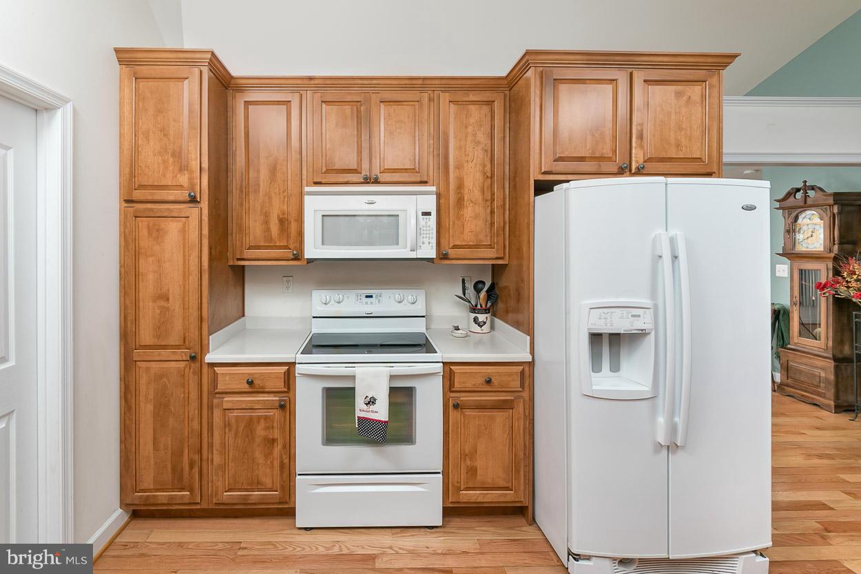 3726 Grave Run Road Hampstead, MD 21074 - Photo 11 of 30 a white refrigerator freezer and a stove sitting inside of a kitchen