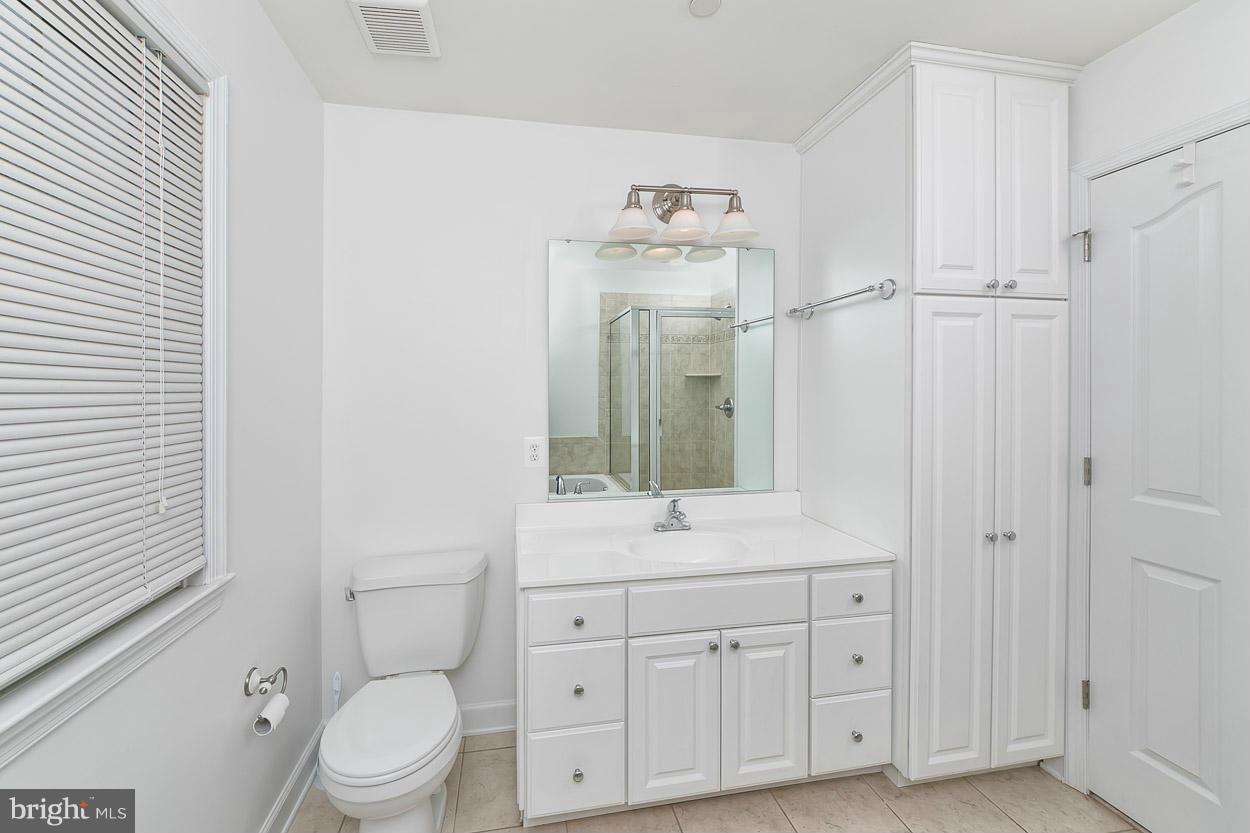 3726 Grave Run Road Hampstead, MD 21074 - Photo 19 of 30 a bathroom with a toilet sink and mirror