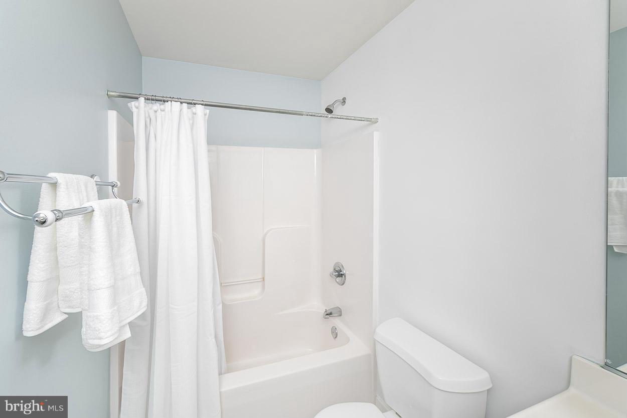 3726 Grave Run Road Hampstead, MD 21074 - Photo 22 of 30 a bathroom with a shower curtain and a toilet