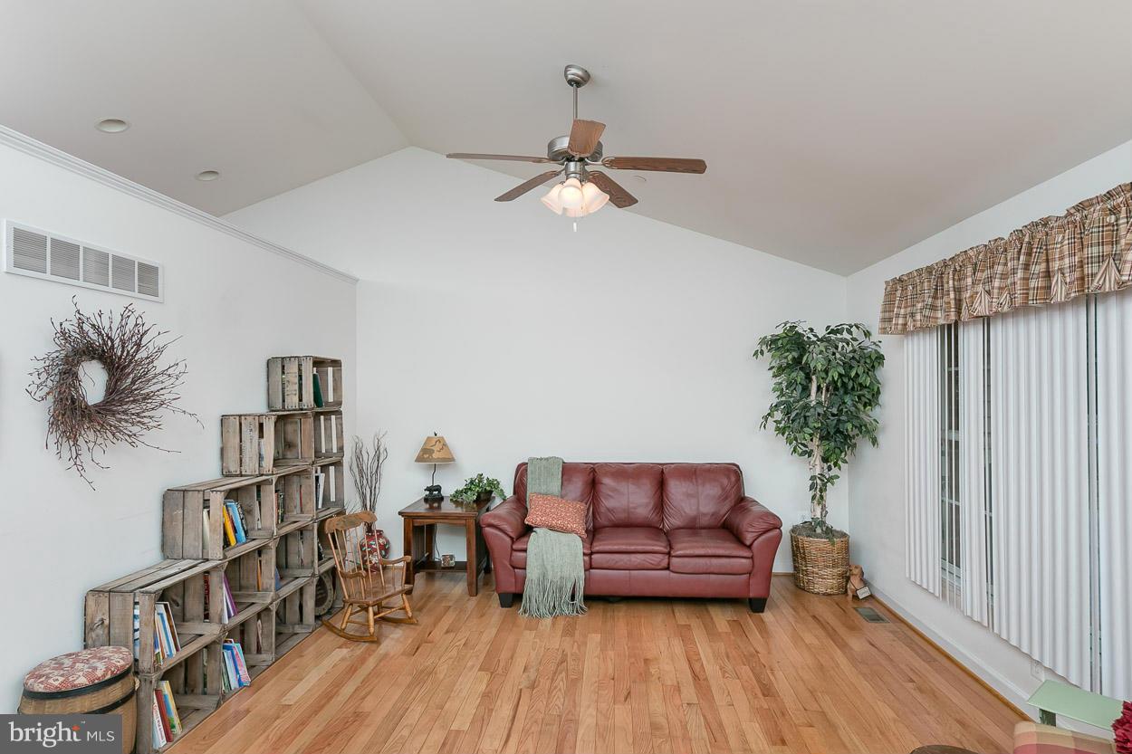 3726 Grave Run Road Hampstead, MD 21074 - Photo 6 of 30 a living room with furniture and a book shelf