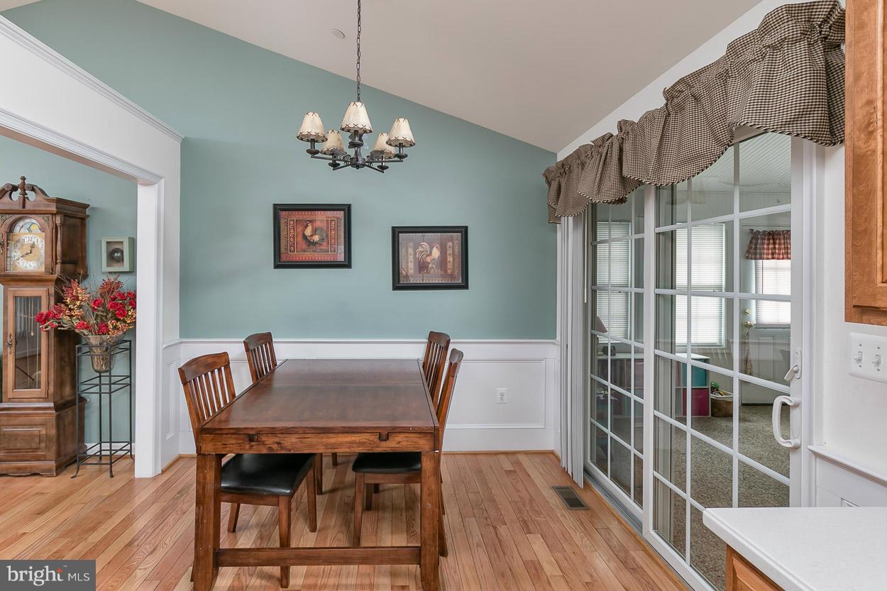 3726 Grave Run Road Hampstead, MD 21074 - Photo 7 of 30 a view of a dining room with furniture and wooden floor