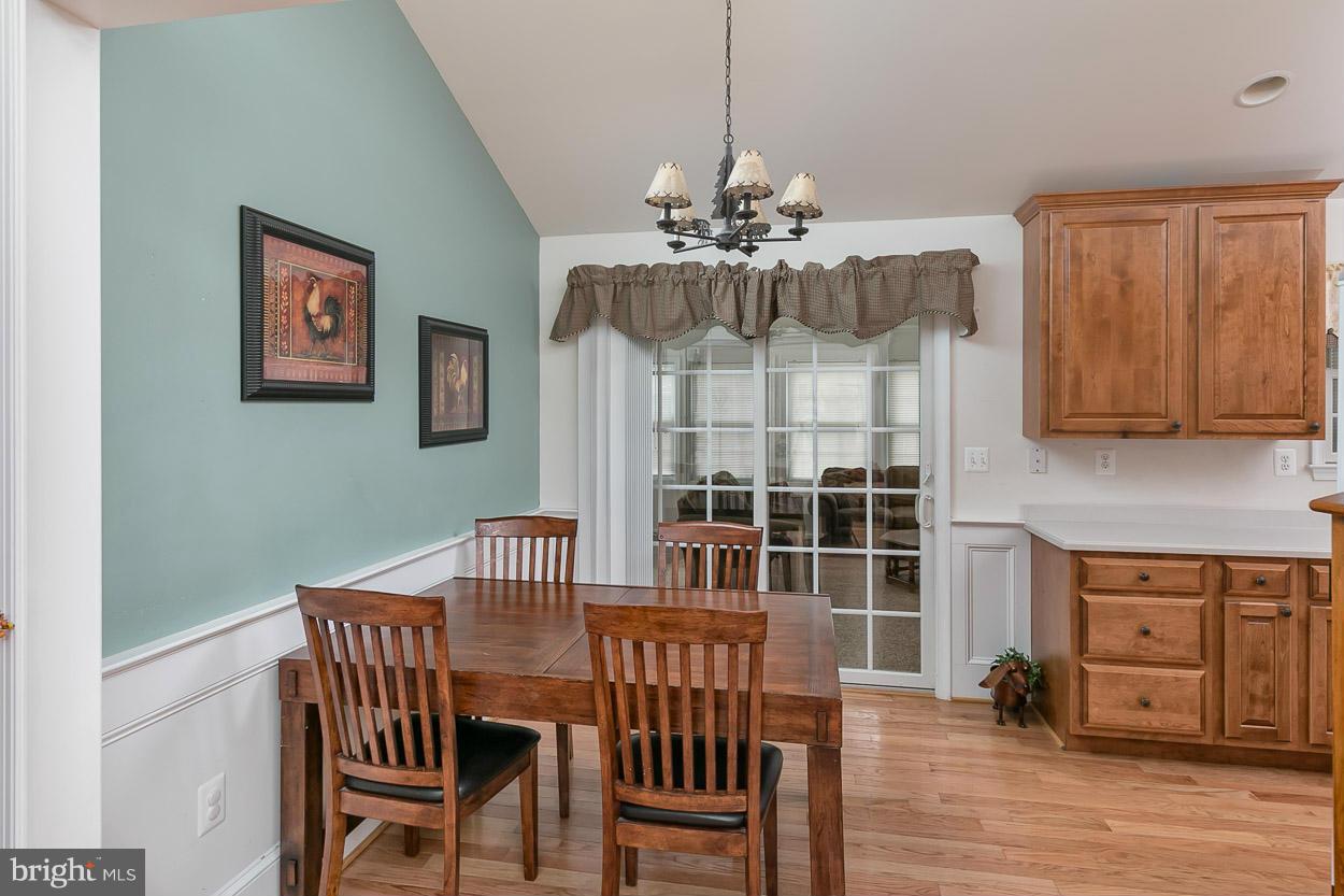 3726 Grave Run Road Hampstead, MD 21074 - Photo 8 of 30 a view of a dining room with furniture wooden floor and chandelier