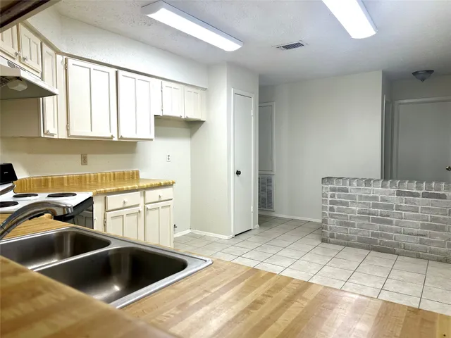 a kitchen with a stove a sink and a refrigerator