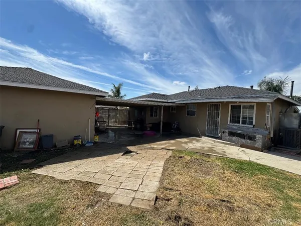 a front view of a house with a yard outdoor seating and garage