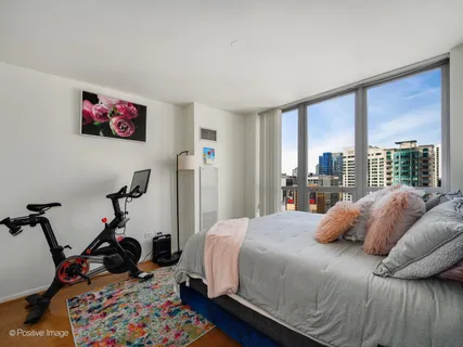 a bedroom with a bed and a large window