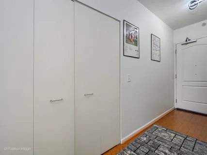 a view of room with hardwood floor and hallway