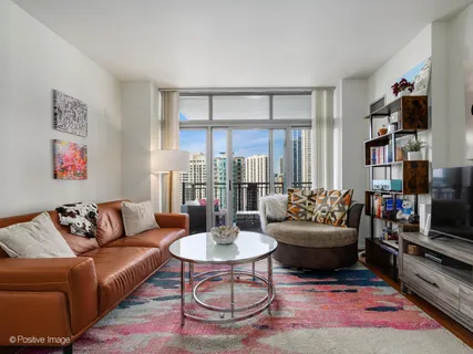 a living room with furniture and a book shelf