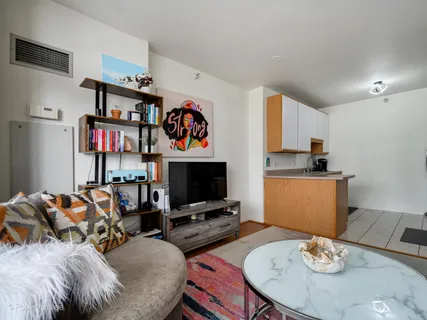 a bedroom with furniture and a flat screen tv