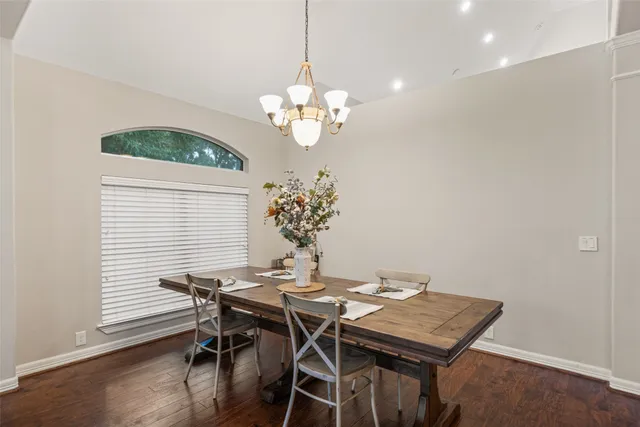 a view of a dining room with a table and chairs