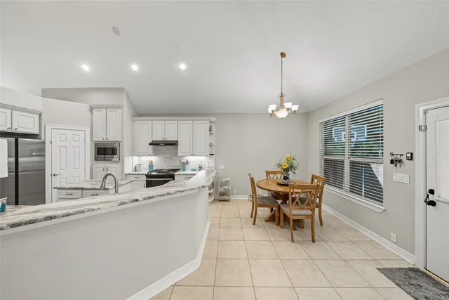 a kitchen with granite countertop sink cabinets and window