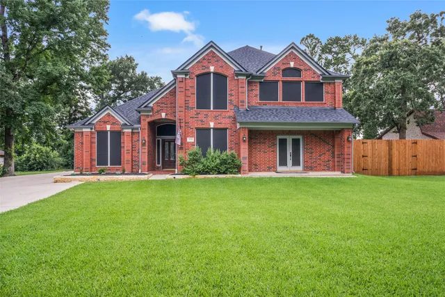 a front view of a house with a garden and yard