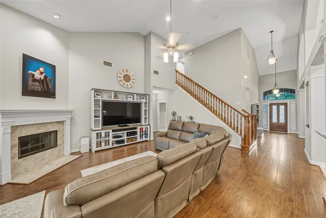 a living room with furniture a flat screen tv and a fireplace