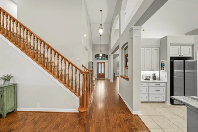 a view of a kitchen with a sink and refrigerator