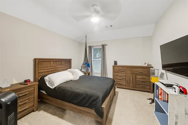 a bedroom with a bed and flat screen tv