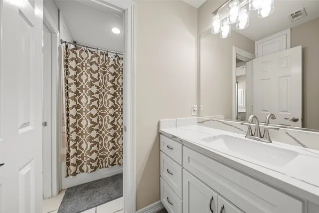 a bathroom with a sink double vanity and a shower