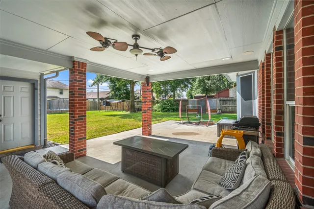 a living room with patio furniture and a floor to ceiling window