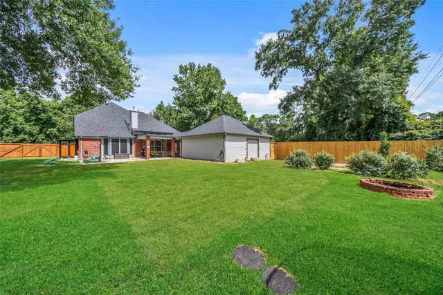 a view of an house with backyard space and garden