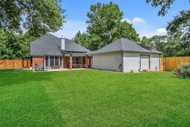 a front view of a house with a yard and trees