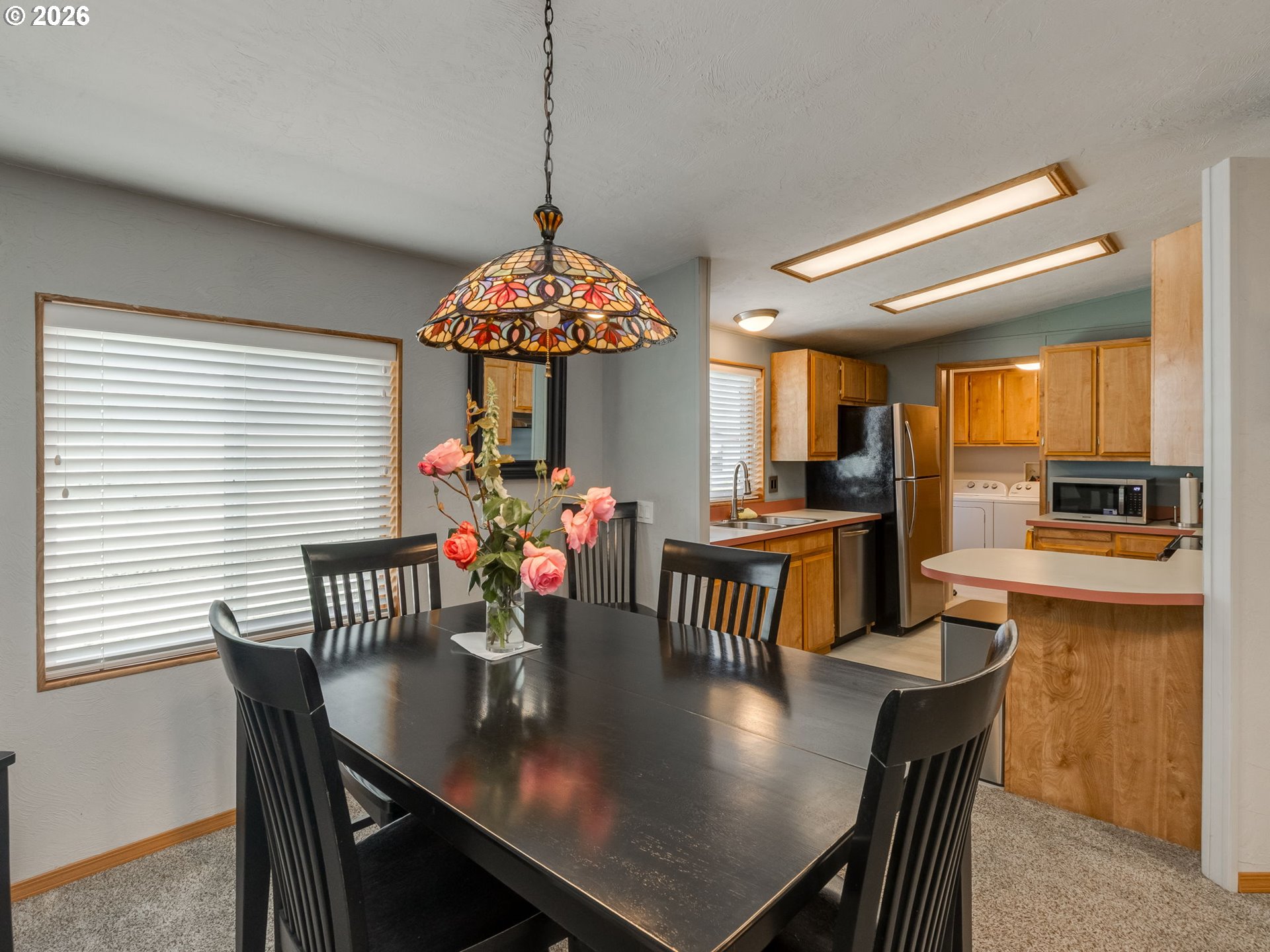 4730 Auburn Road Northeast, Unit 125 Salem, OR 97301 - Photo 6 of 36 a view of a dining room and chandelier