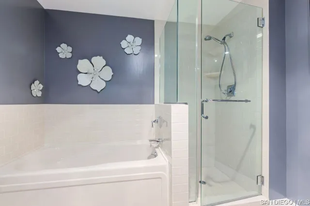 a bathroom with a bathtub and a shower