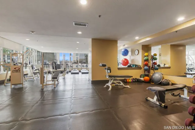 a view of a room with lots of gym equipment