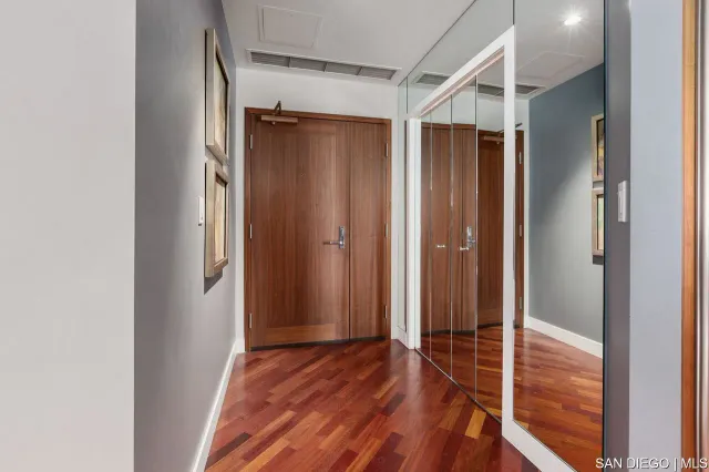 a view of hallway with wooden floor
