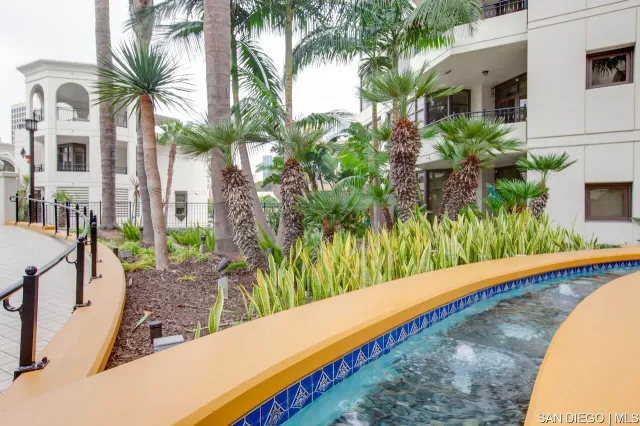 a view of a building with sitting area and potted plants